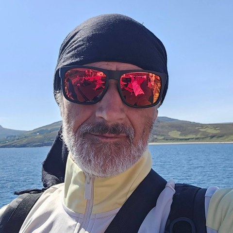 Daz out on the water, hills behind him